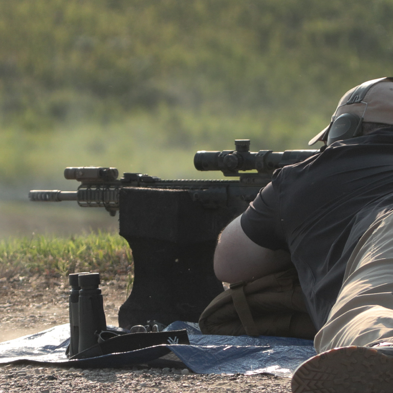 A man firing a rifle