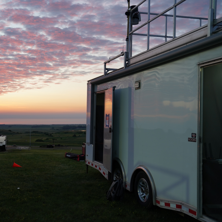 The Command Trailer deployed in a grassy area at dusk