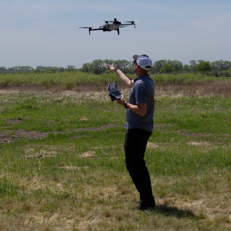 A man launching a small unmanned vehicle