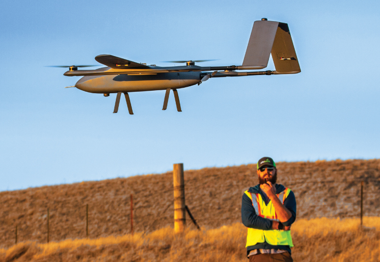 Man observing an unmanned vehicle in flight