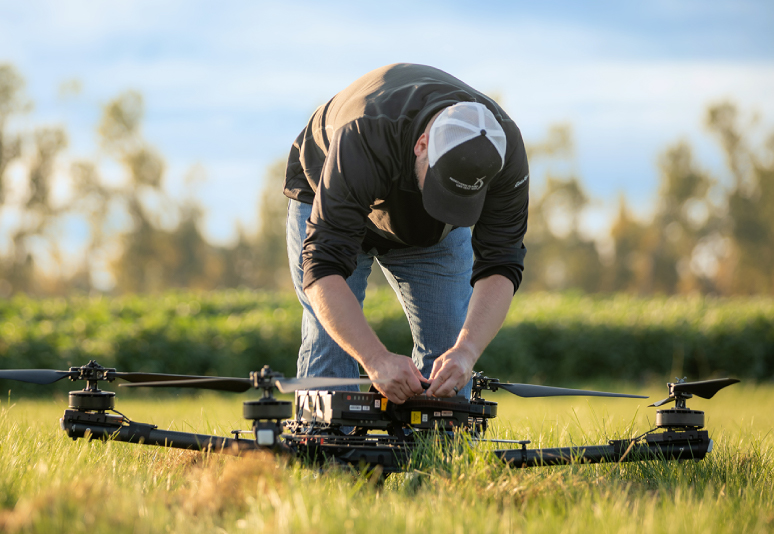 A man adjusting an unmanned vehicle