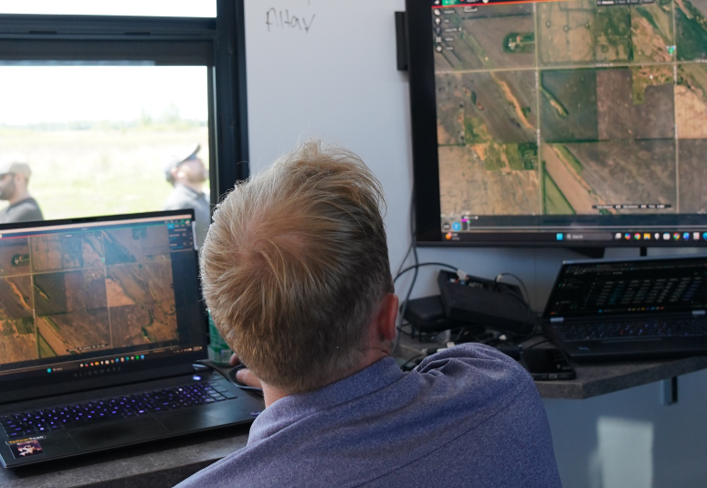 A man viewing an aerial photograph on a computer