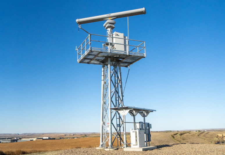 A short, remote radar with a facility in the background